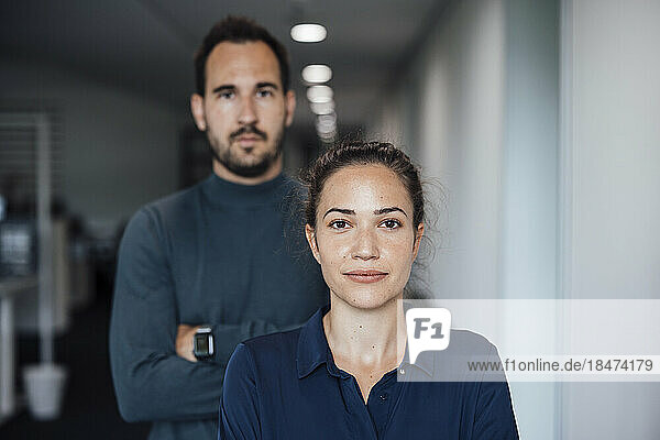Young businesswoman with businessman in office
