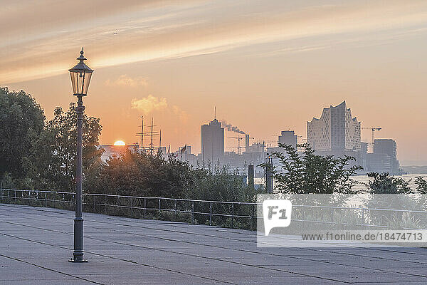 Germany  Hamburg  Lone street light standing in paved area at sunset
