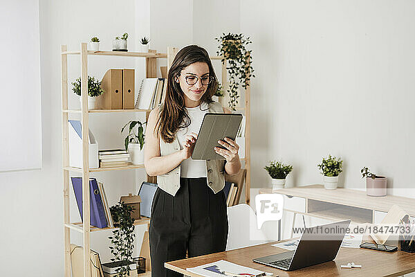 Businesswoman using tablet PC in office