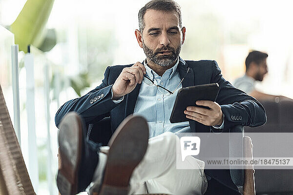 Businessman with eyeglasses using tablet PC