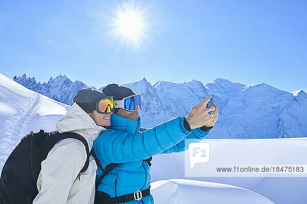 Happy mature couple taking selfie through mobile phone