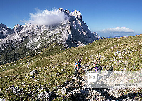 Friends hiking at Furchetta on sunny day  Dolomites  Italy