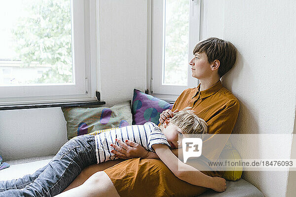 Woman spending leisure time with son at home