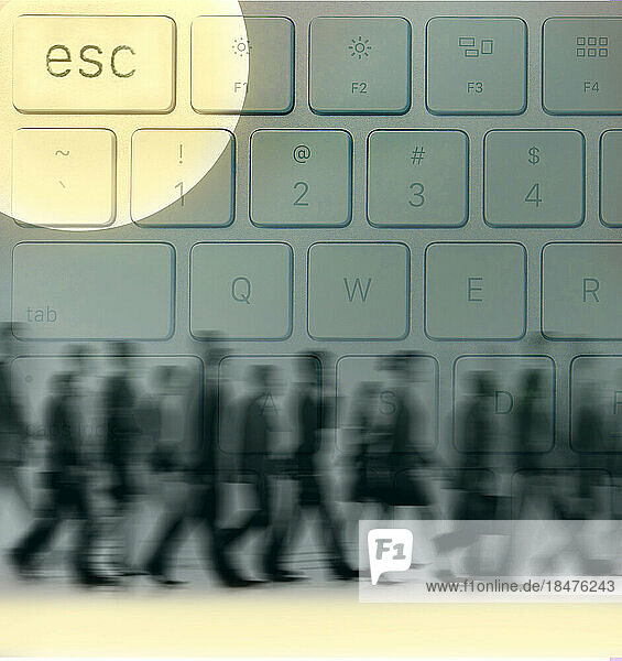 Blurred motion of group of people walking past keyboard with highlighted ESC key