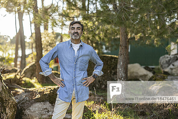 Portrait of confident mature man standing in nature
