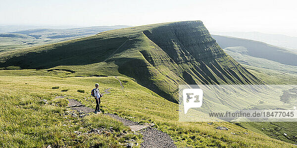 Woman standing at mountain on sunny day  Brecon Beacons  Wales