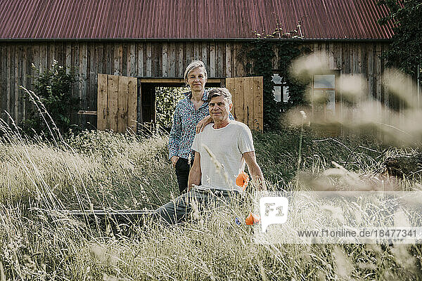 Owner couple in front of barn