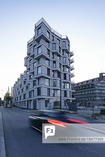 Germany  Bavaria  Munich  Car passing newly built apartment building