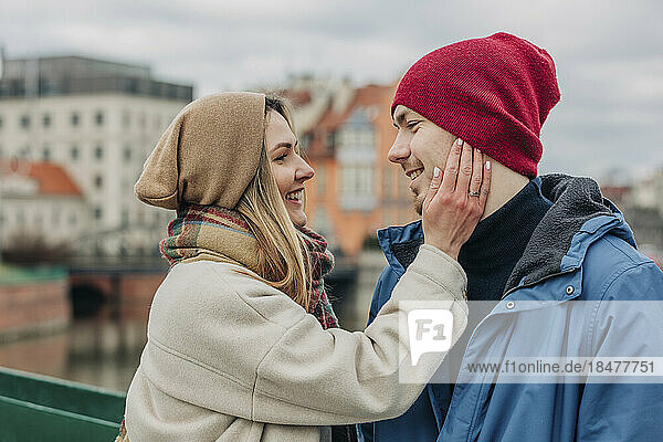 Romantic woman touching boyfriend's face