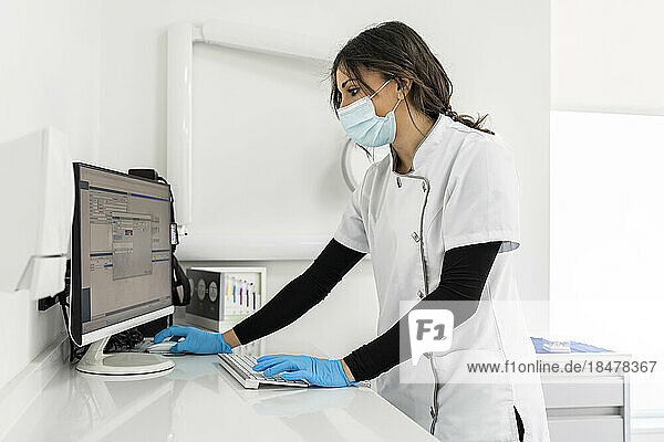Nurse working on computer at medical clinic