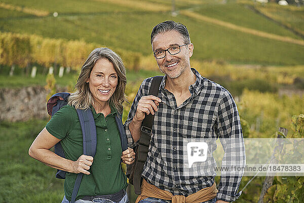 Happy mature couple standing together on hill