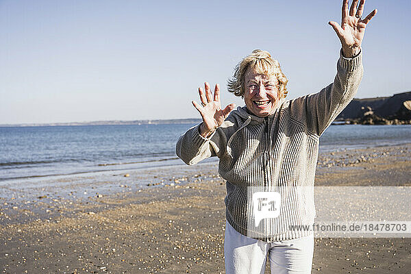 Cheerful elderly woman at beach on vacation