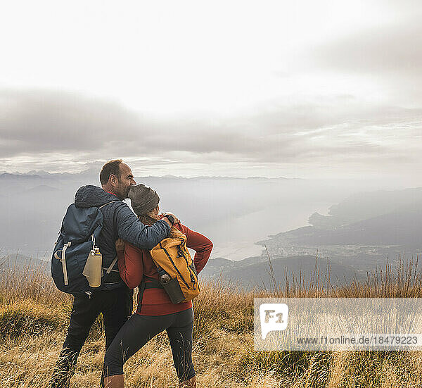 Loving mature couple standing together on mountains