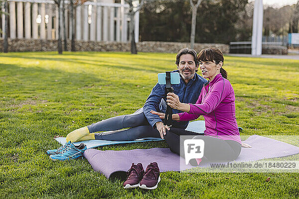 Happy mature couple taking selfie through smart phone