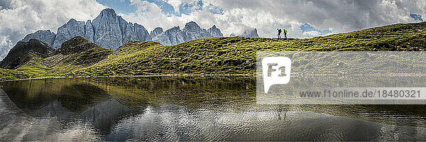Man and woman hiking by lake at Forcella Venegia  Dolomites  Italy