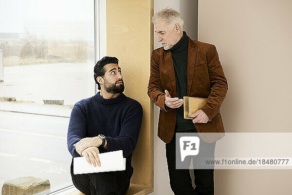 Businessman talking with colleague in office