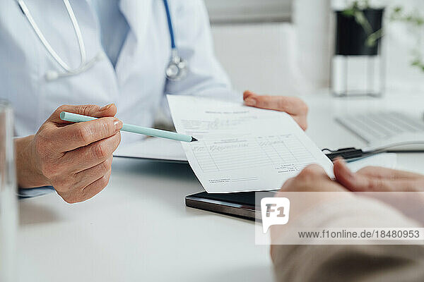 Doctor explaining prescription to patient at clinic