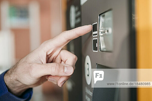 Hand of businessman touching ticket machine