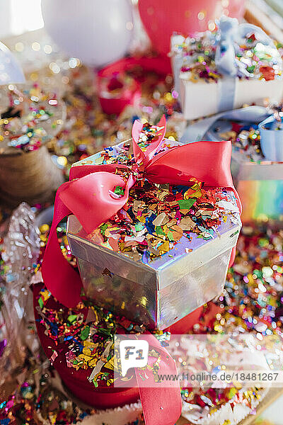 Gift box with confetti on desk