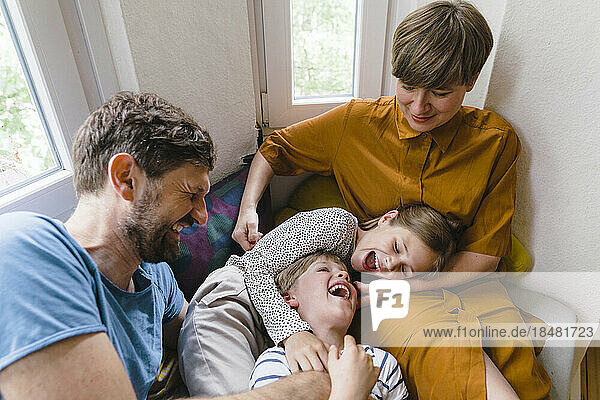 Man and woman enjoying with children at home