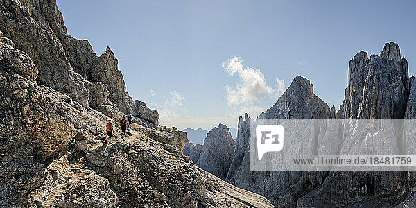 Man and women hiking on sunny day at Mont Mulaz  Dolomites  Italy