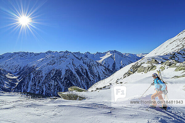 Österreich  Tirol  Sonne scheint über einer Skifahrerin in den Zillertaler Alpen