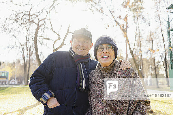 Smiling senior man with woman at autumn park