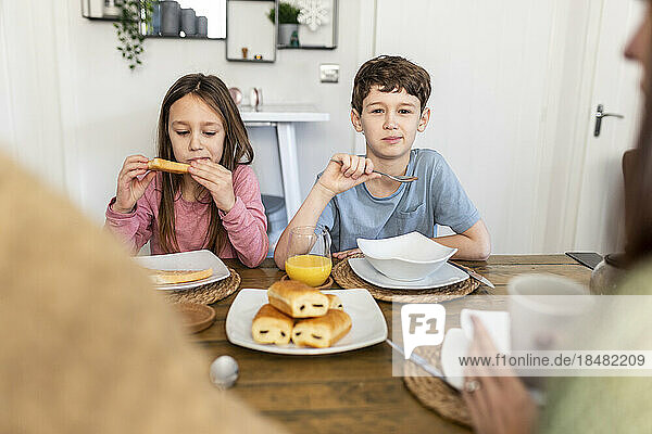 Family together having breakfast in kitchen