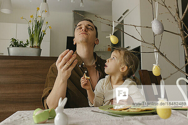 Father and daughter enjoying pancakes for breakfast at home