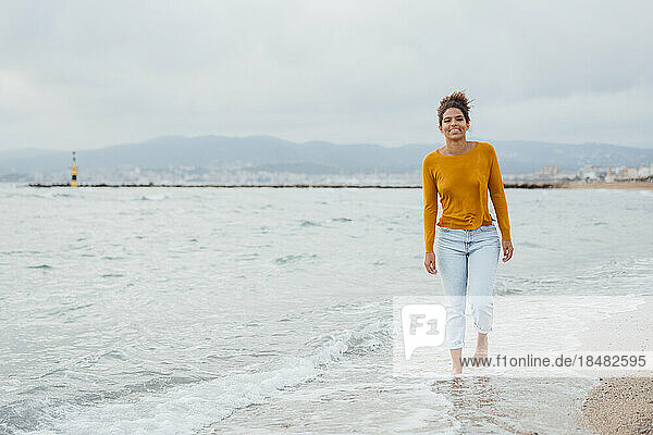 Happy woman walking at seashore