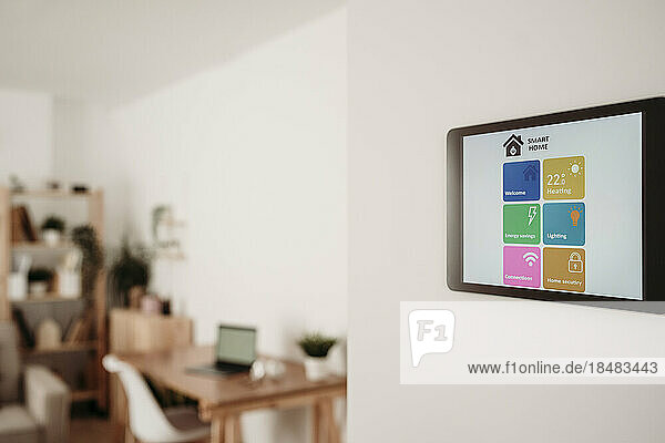Home automation app on tablet PC in living room at home