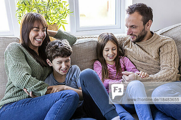 Happy family enjoying together in living room at home