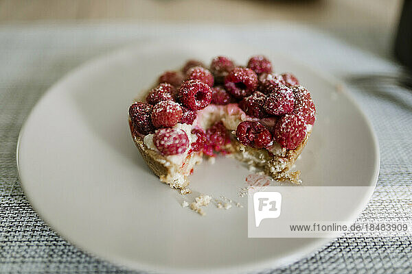 Delicious raspberry cake on plate on table