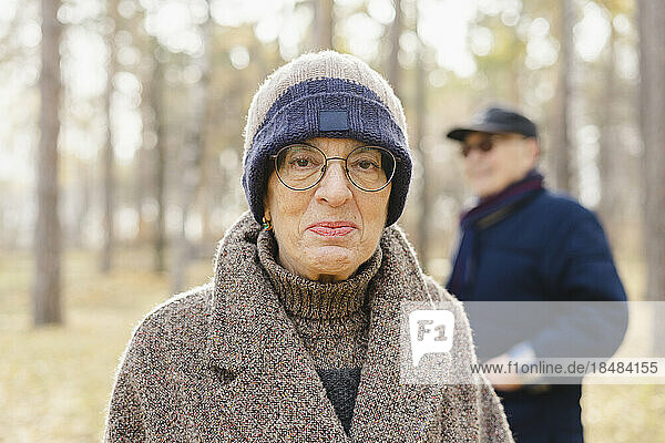 Senior woman wearing eyeglasses and knit hat at park