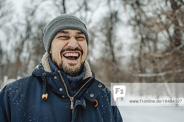 Happy man having fun in snow