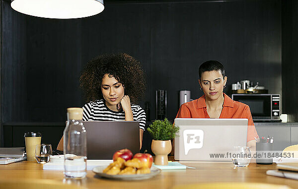 Freelancers working through laptop at table