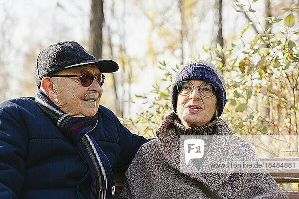 Senior woman talking to man at autumn park