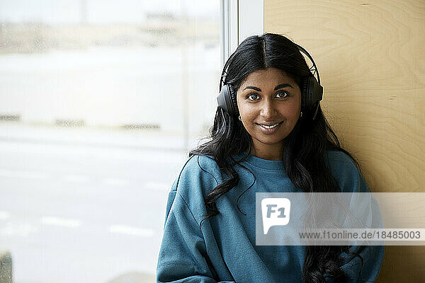 Smiling woman wearing bluetooth headphones