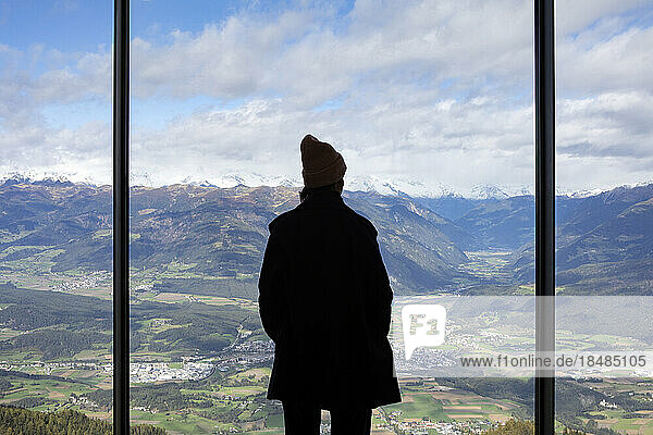 Mature woman looking at mountain range from museum