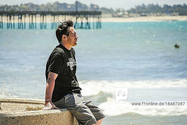 A man looking the ocean near Ventura Pier