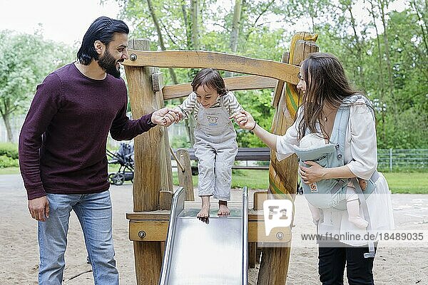 Family with children on a playground  Bonn  Germany  Europe