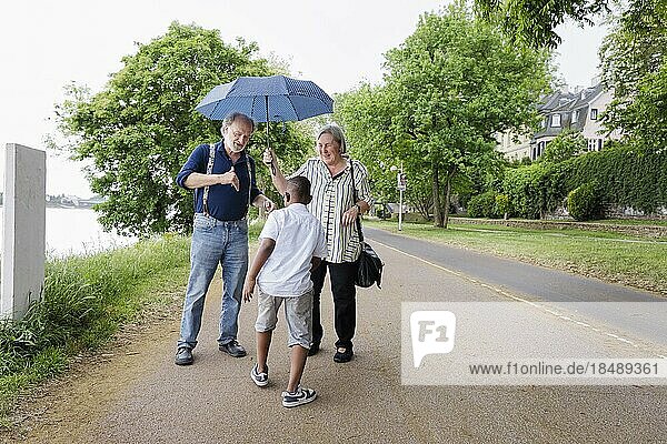 Temporary grandparents. Elderly couple volunteer to look after a boy from Africa for a few hours a week.  Bonn  Germany  Europe