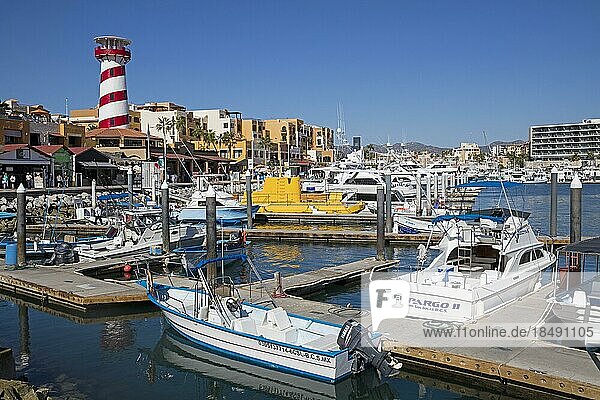 Lighthouse and pleasure boats moored in marina of the port of seaside resort Cabo San Lucas on the peninsula of Baja California Sur  Mexico  Central America