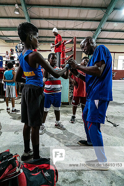 Young boxer being gloved up by trainer  Boxing Academy Trejo  Havana  Cuba  West Indies  Caribbean  Central America