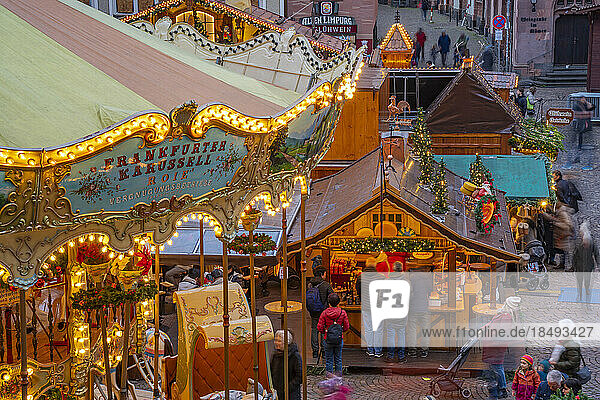 View of carousel and stalls of Christmas Market  at dusk  Roemerberg Square  Frankfurt am Main  Hesse  Germany  Europe
