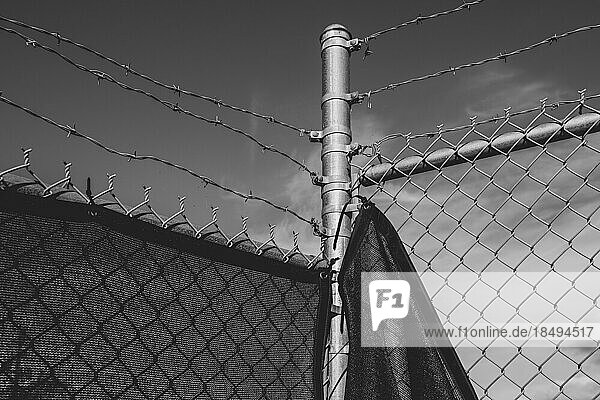 Stock photo of barbed wire fence and draped fabric.