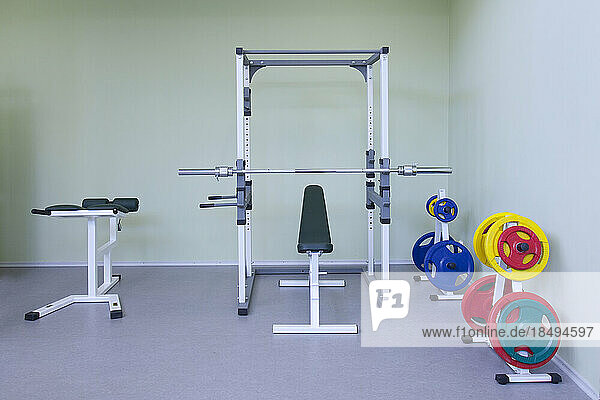 A fitness room  gym equipment  weights and fitness and sports training equipment  in a school.