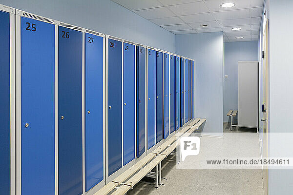 Sports and exercise facilities indoors in a gym  changing rooms  lockers with blue doors.