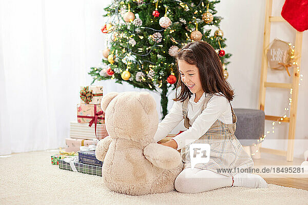 Smiling young girl with teddy bear
