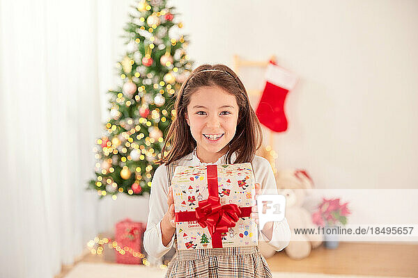 Smiling young girl with Christmas present